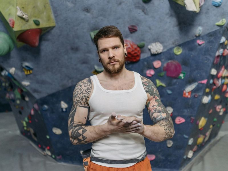 Close-up of a man concentrating during a static strength hold exercise.